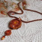 Lady in Orange pendant necklace is embroidered with Swarovski crystals, Miyuki seed beads and magic beads.
